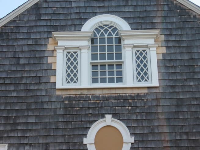 Exterior view of new wood window on shingle-style home