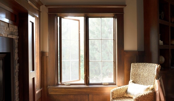 Double stained wood casement windows with grilles