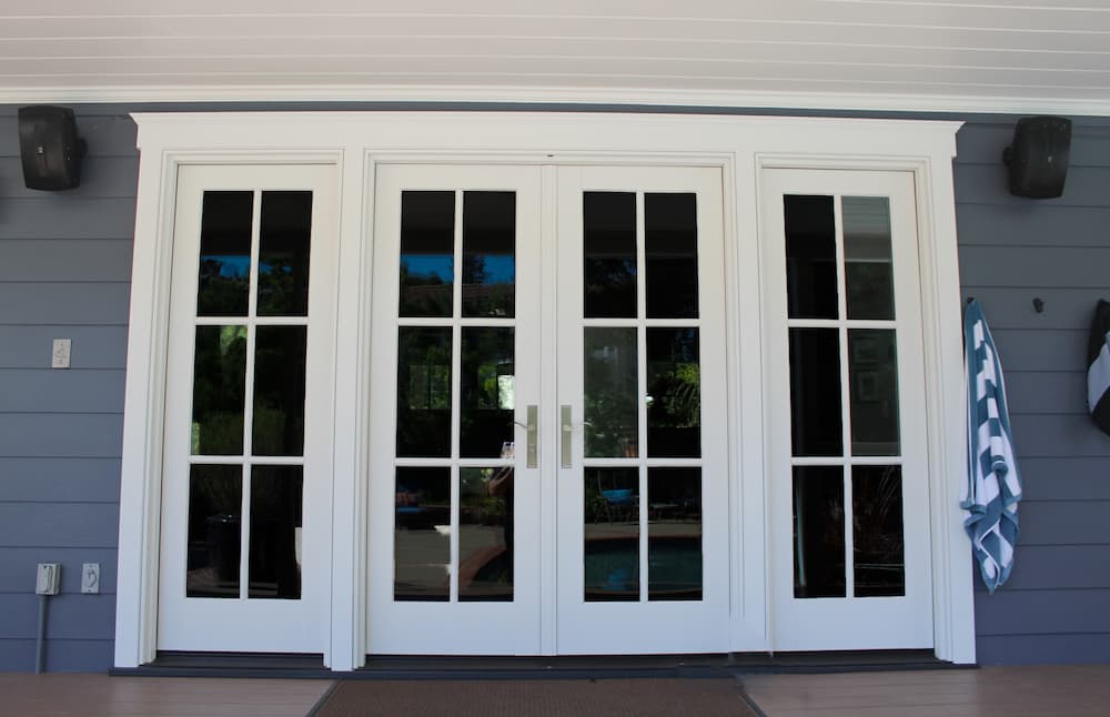 White French patio doors with grilles and silver hardware.