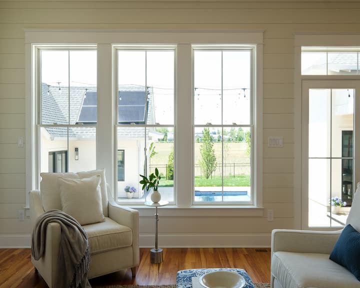 Three white double-hung windows in living room