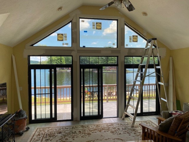 View of lake through new black picture windows and sliding patio doors.