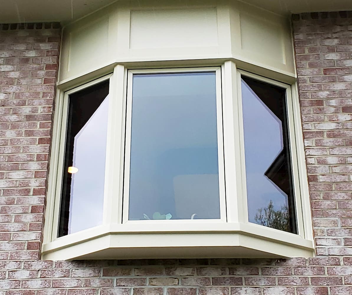 Exterior view of new wood window on brick home