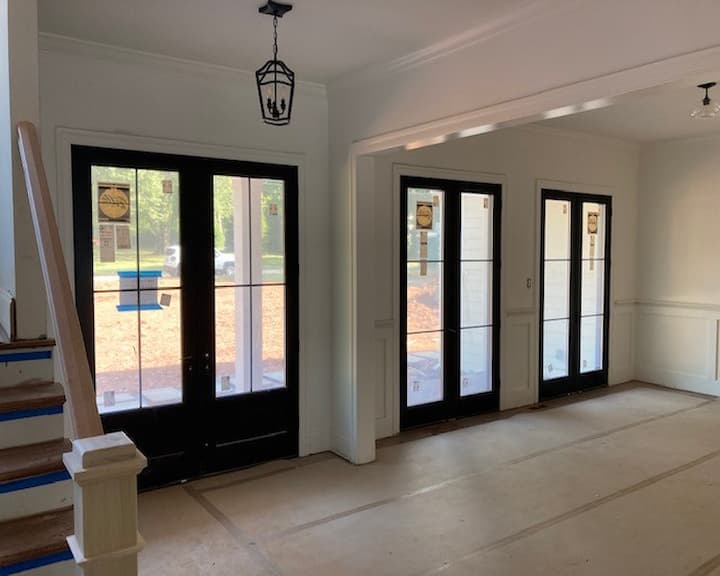 Three back double French patio doors in a row on a home's back patio