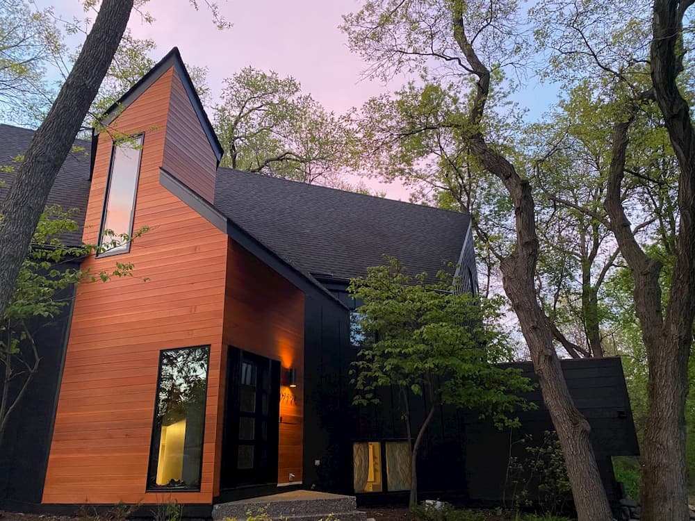 Minnetonka home angled view of front entry with views of black casement windows