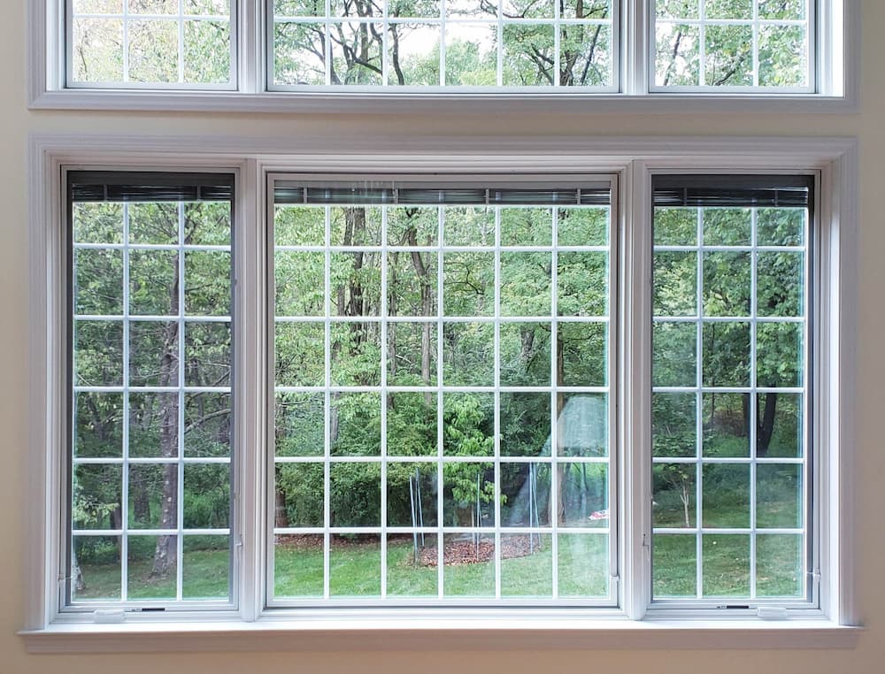 Fixed and casement wood windows with traditional grille patterns