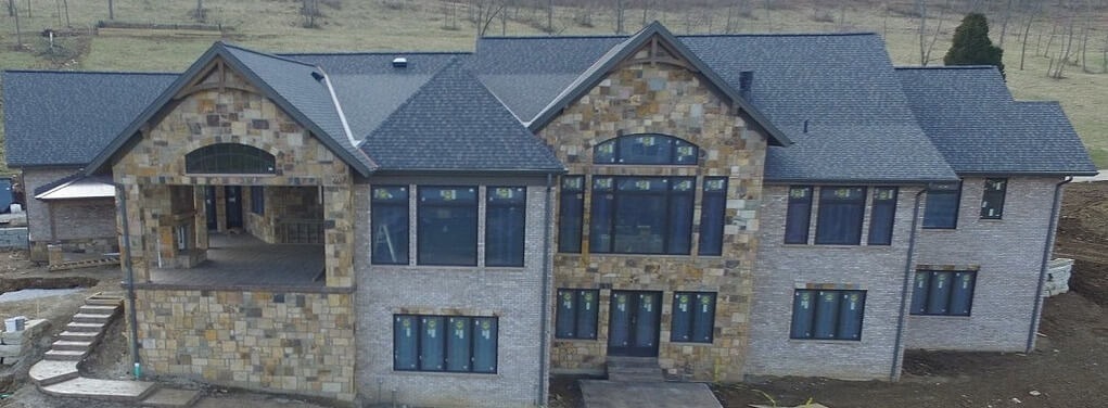 Stone home with large amount of windows