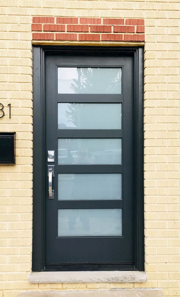 New black fiberglass front door contemporizes entryway.