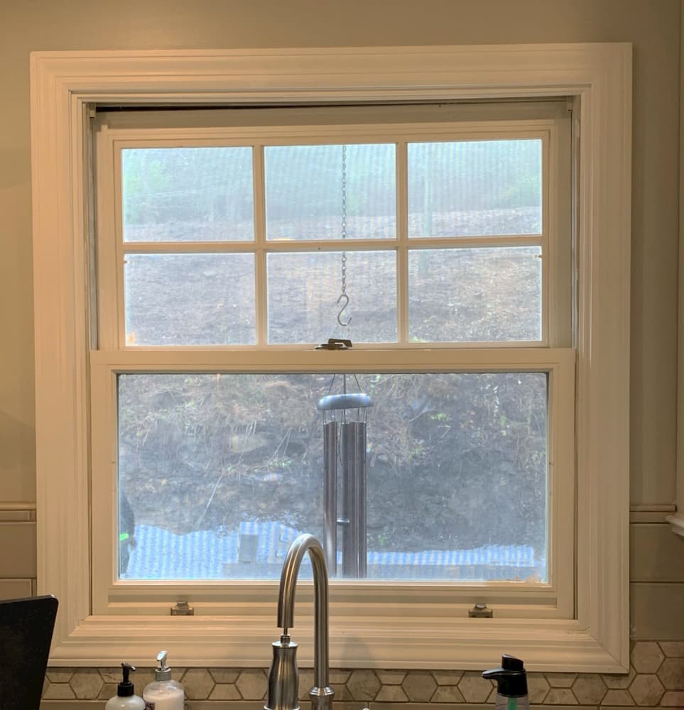 Interior view of old white double-hung kitchen window