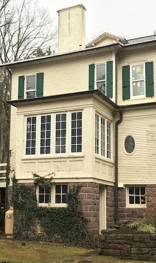 Exterior view of home with new wood wood double-hung windows