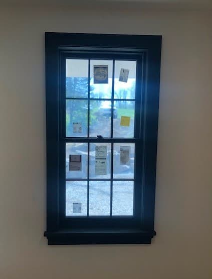 Interior view of a new wood double-hung window with traditional grille pattern