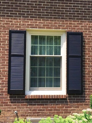 front of home in philadelphia gets beautiful new windows with black shutters