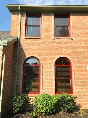 brick home replacement with red windows