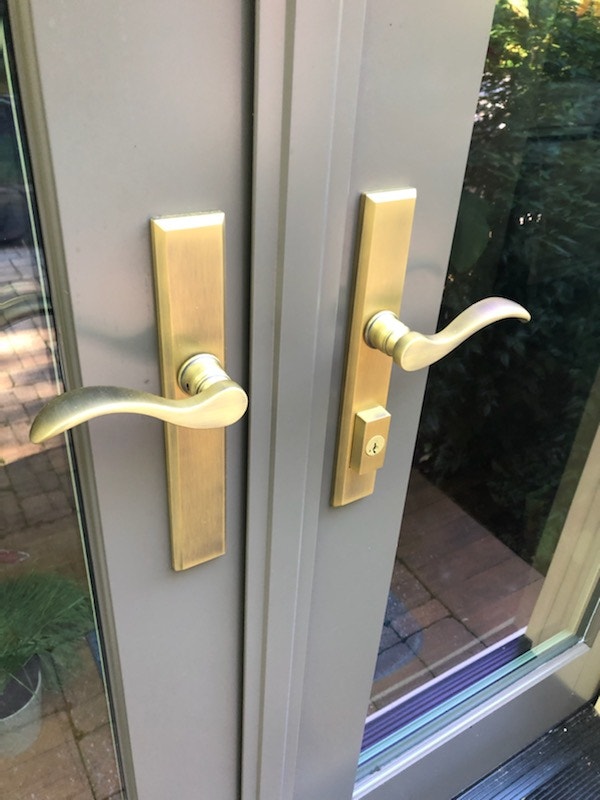 close up of gold hardware on hinged French patio door