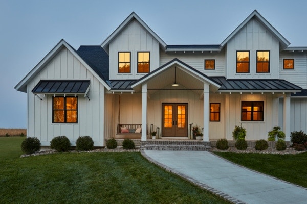 Light gray home featuring Pella windows with black trim and grilles