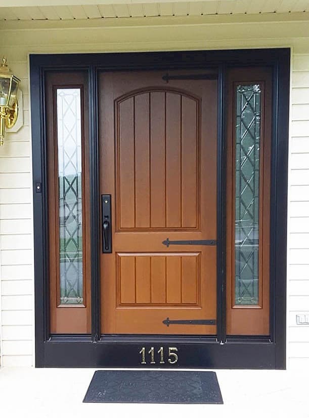 Exterior view new wood-grain fiberglass entry door with dual sidelights