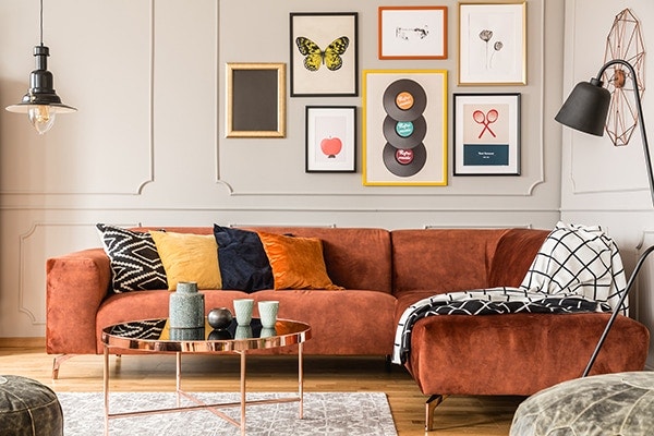 Upholstered sofa with soft pillows reduces noise from wall in living room