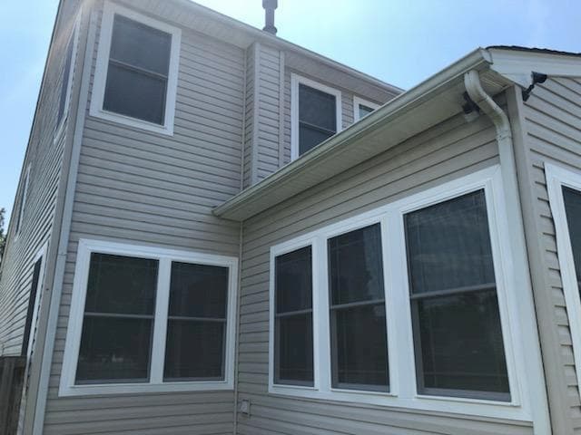 Exterior view of home with new fiberglass double-hung windows