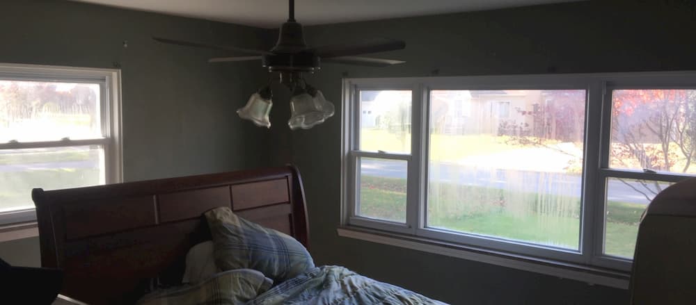 Interior view of a bedroom with old double-hung windows