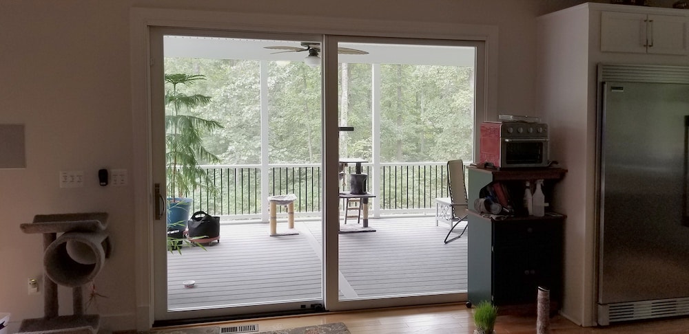 Interior of new sliding glass doors looking out onto patio in Mineral, VA home