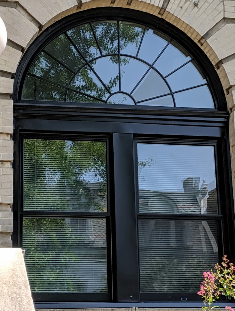 Black wood double-hung windows with half-circle transom