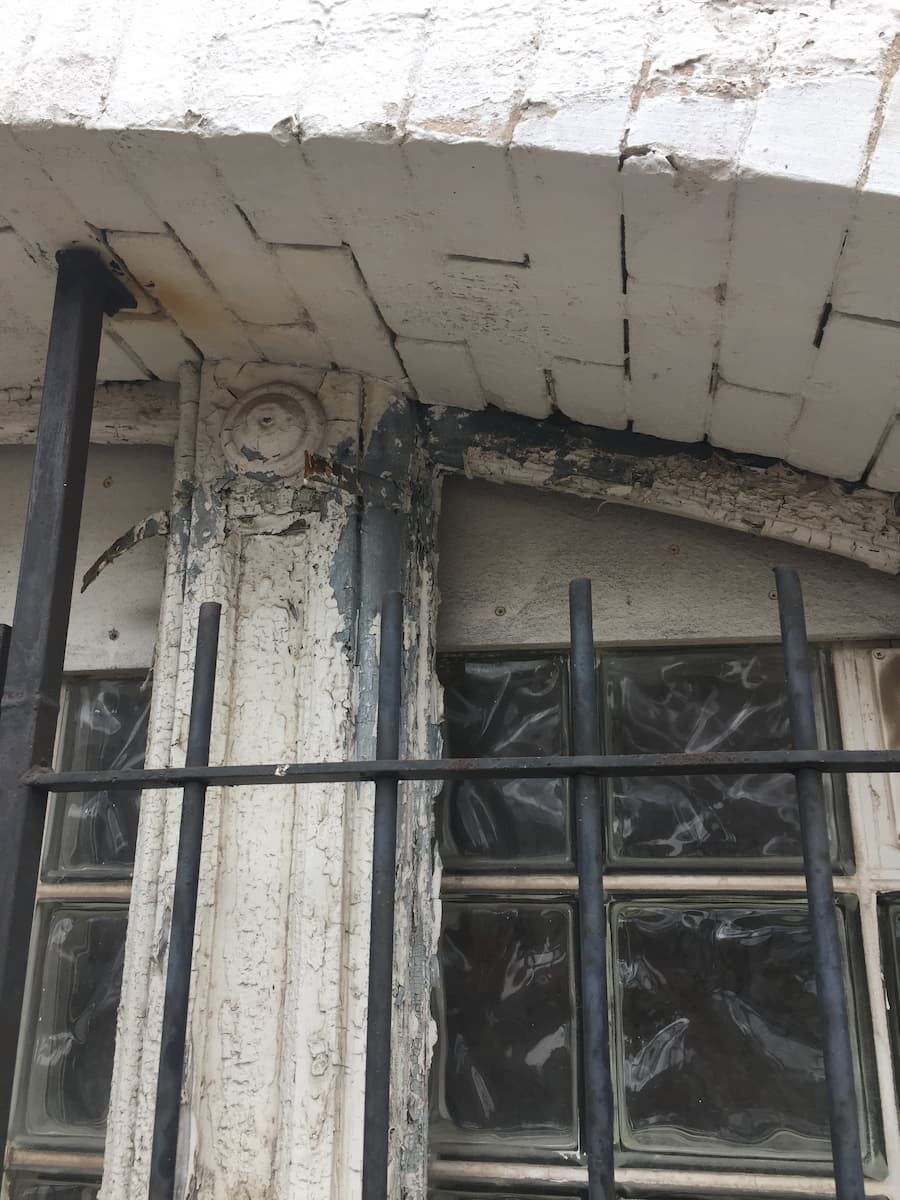 Old, damaged windows on brick building