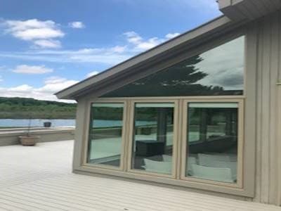 Exterior view of deck with lifestyle series fixed wood windows with a view of a lake
