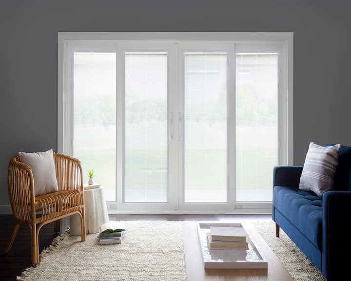 Four-panel vinyl sliding patio door with blinds in a living room
