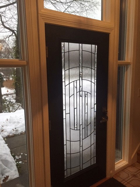 Interior of fiberglass front entry door with transom windows and sidelights on Westfield home