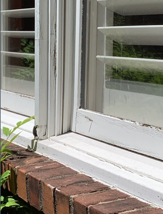 Close-up of deteriorated wood window casings on Franklin, TN, home.