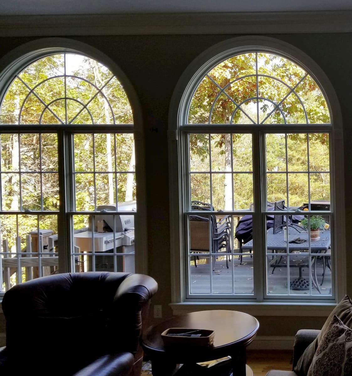 Interior view of wood double-hung windows with half-circle transoms and traditional grilles
