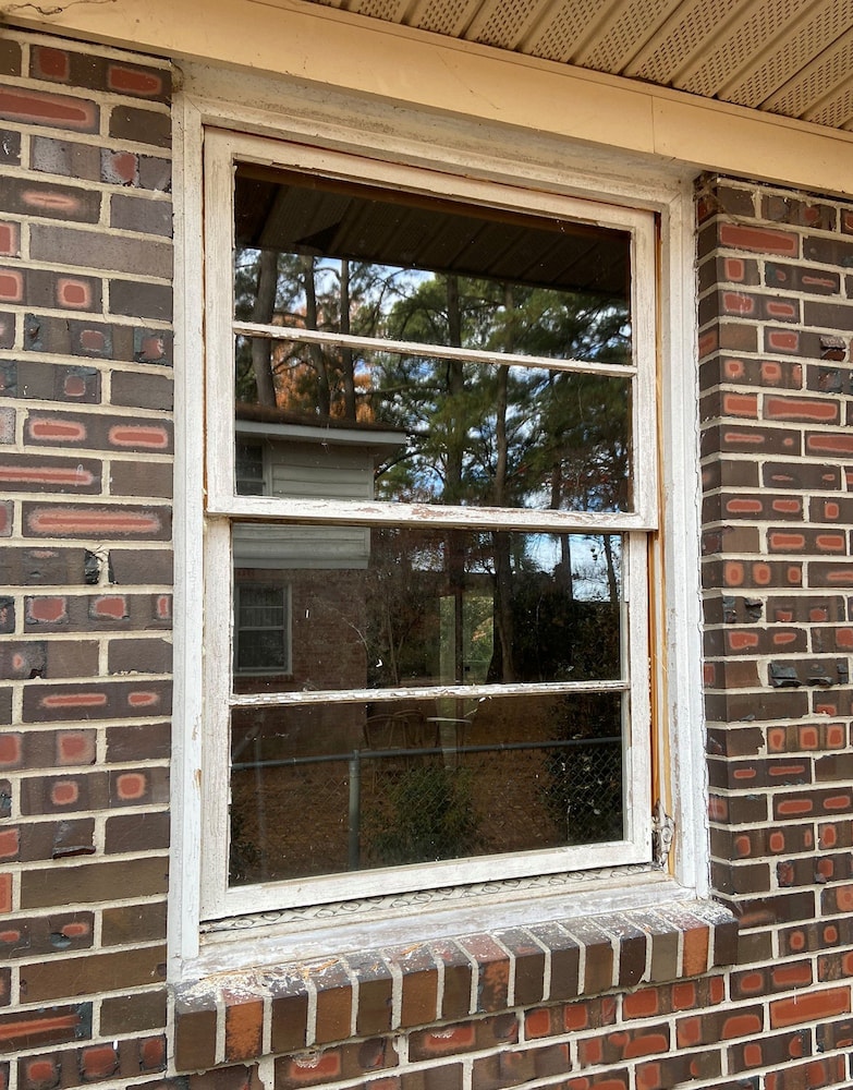 White wood windows on Norfolk home in need of replacement