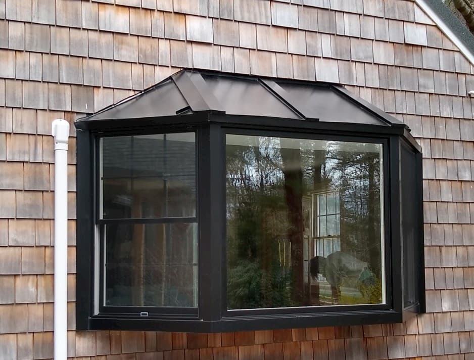Exterior view of new black-clad wood bay window