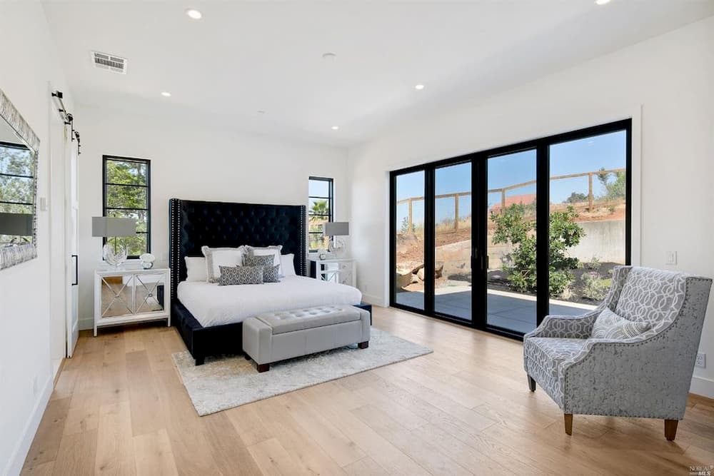 Bedroom with contemporary wood sliding patio doors in a black finish