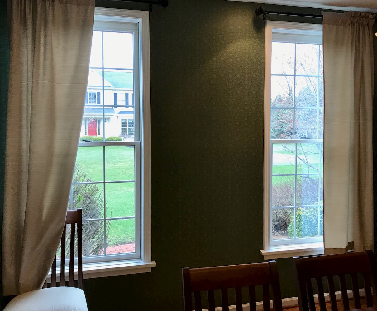 Interior view of two old double-hung windows in a dining room