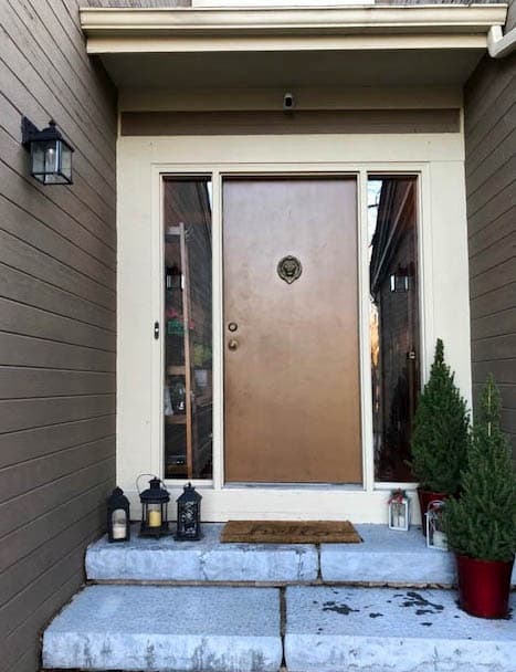 Old brown entry door with two full-length sidelights