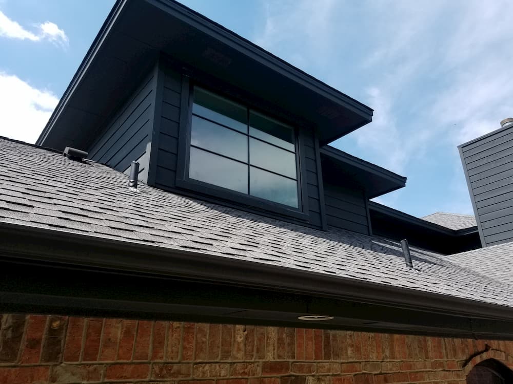 Exterior view of dormer with wood awning window and custom grille pattern