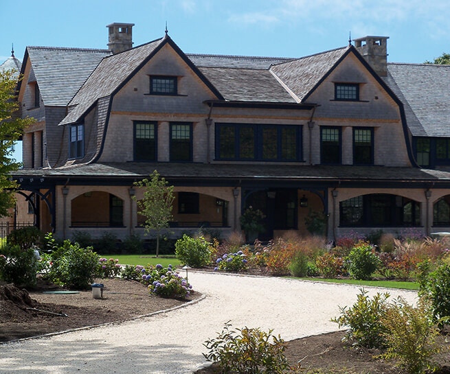 Front exterior of shingle-style home in South County, RI, with new blue wood windows