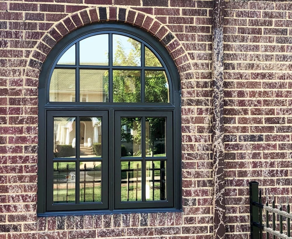 New black casement windows on brick home