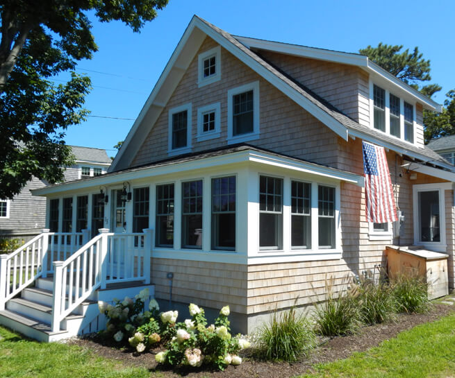 Front entrance of a cottage in Cape Cod, MA, with new wood windows