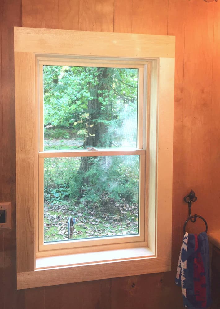 Interior view of wood double-hung window with natural wood trim