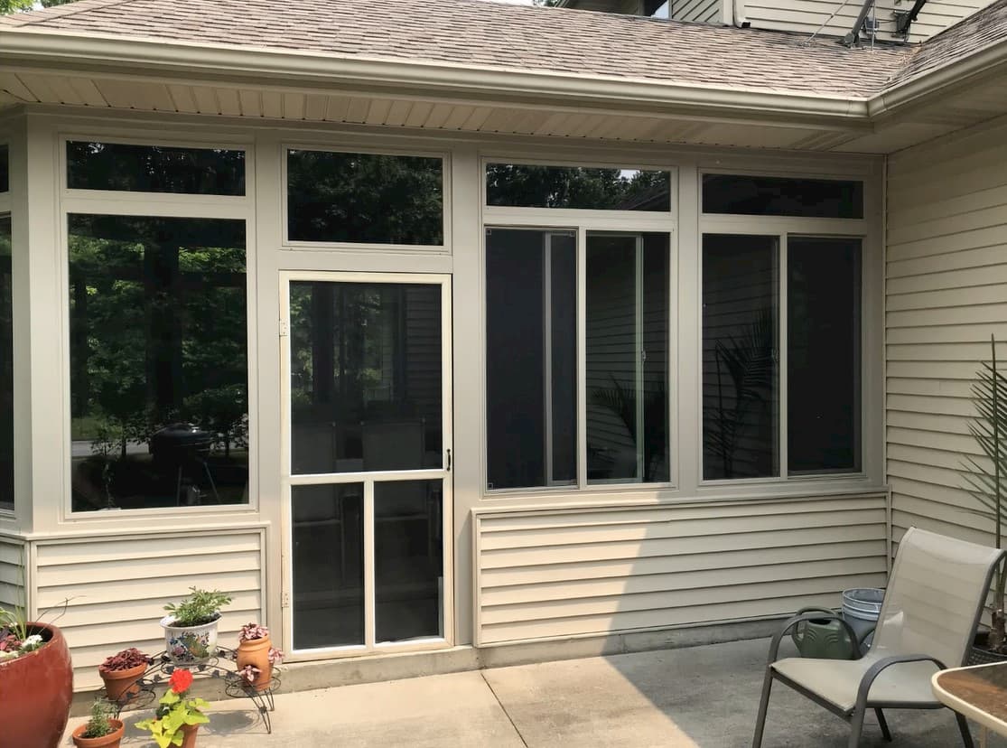 Custom and sliding vinyl windows overlook a back patio
