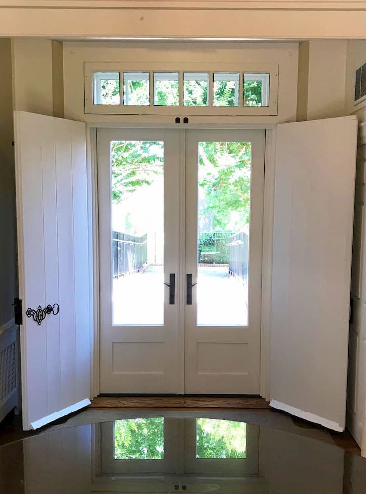 Interior view of new wood French patio doors and transom window