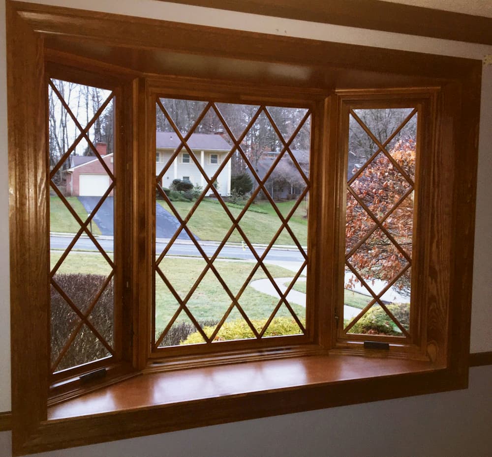 Interior view new wood bay window with diamond grille pattern