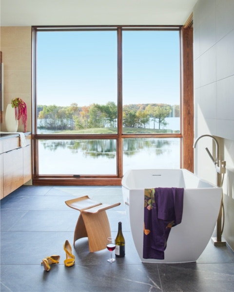 a bathroom with window wall featuring awning windows