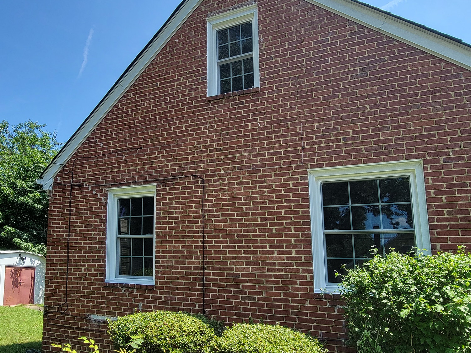 Brick exterior of Richmond home with vinyl double-hung windows