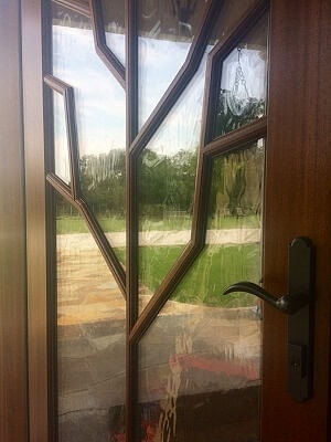 Close up wood glass door with brown hardware