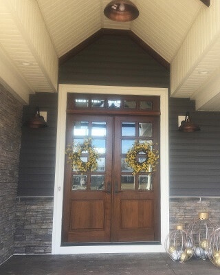 Wood entry door in rustic walnut with unique transom
