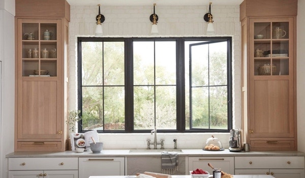 Hinged window combination with black frames and square grilles in a kitchen