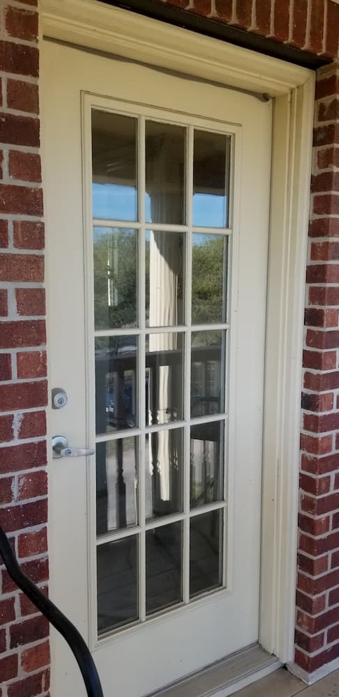 Old hinged patio door with traditional grille pattern