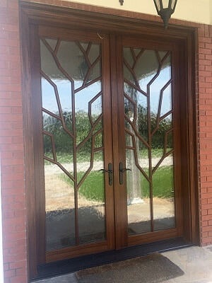 Wood entry doors with brown hardware